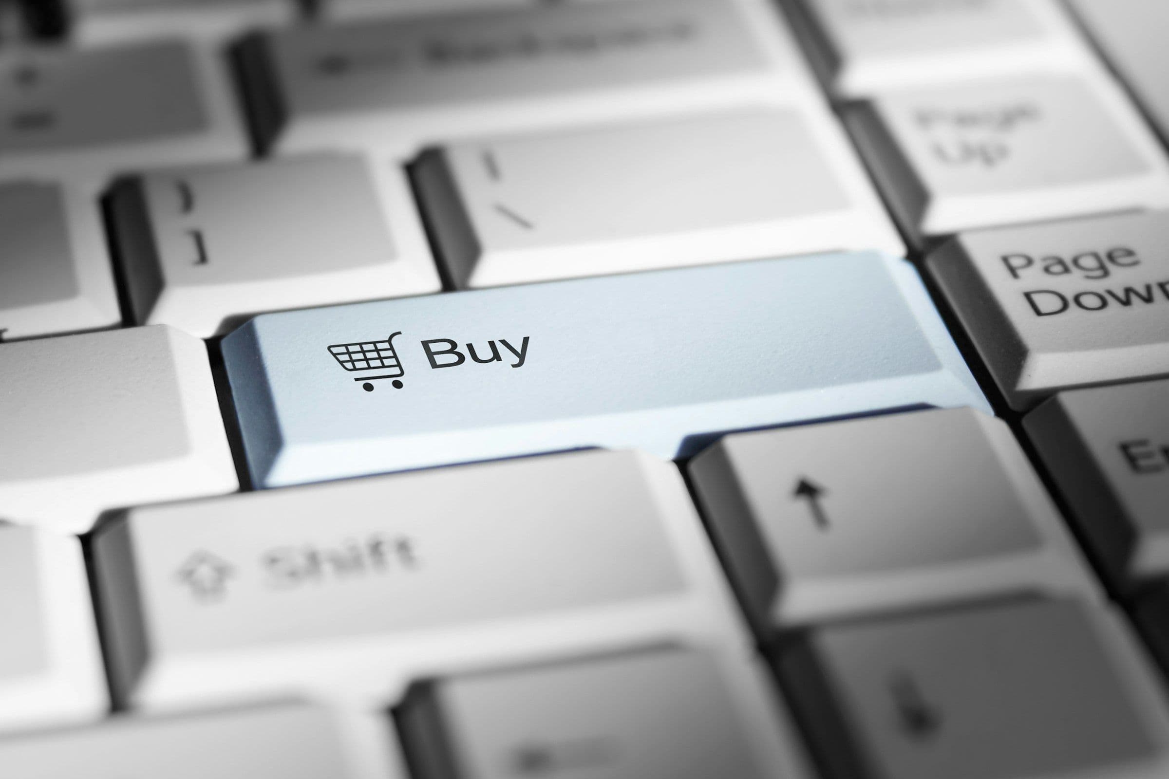 Close-up of a keyboard with a prominent 'buy' button.