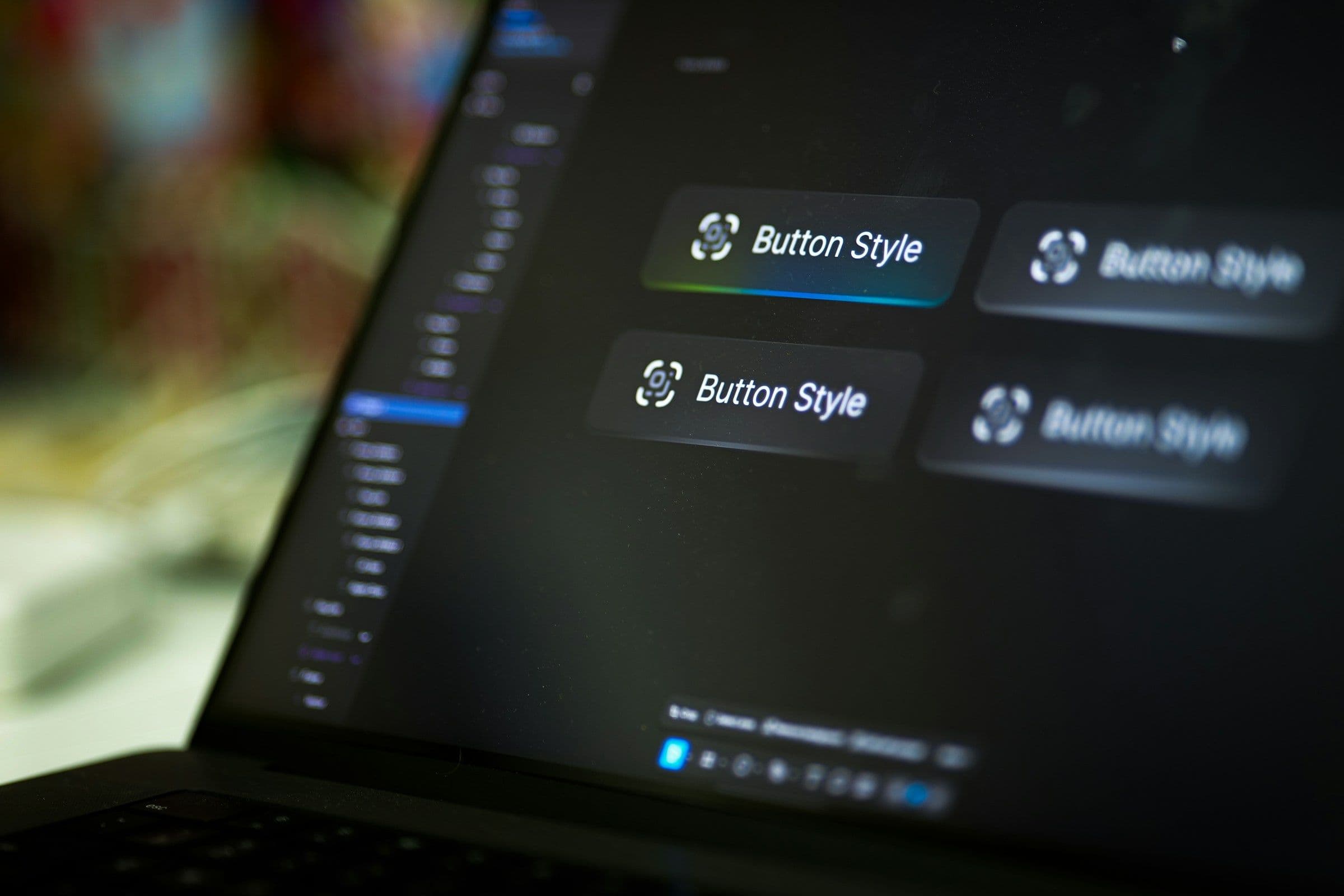 Laptop screen displays four button style options.